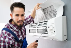 Man cleaning AC